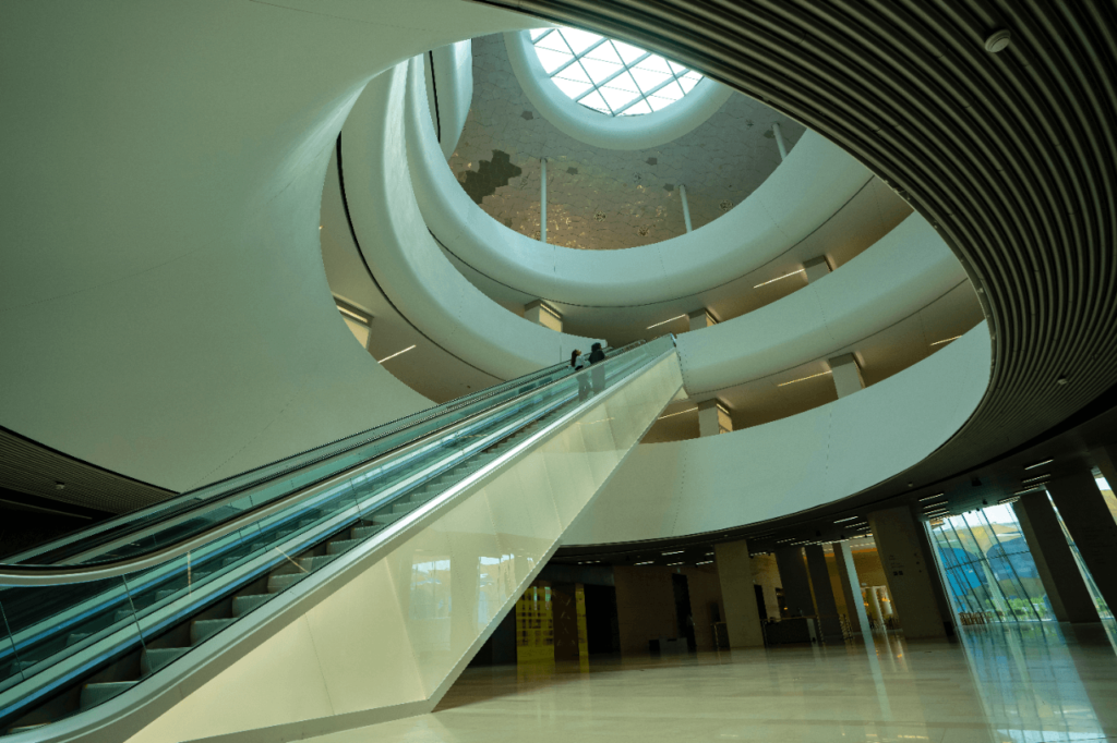 View of two people on the escalators in the King Abdulaziz center for World Culture (Ithra)